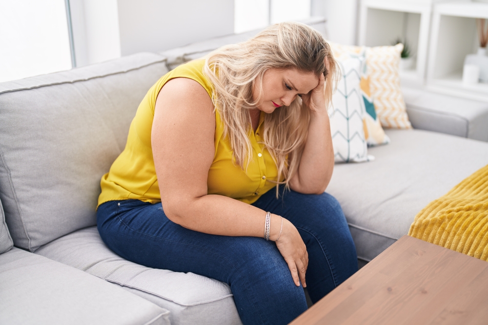 Woman on the couch wondering if semaglutide cause headaches